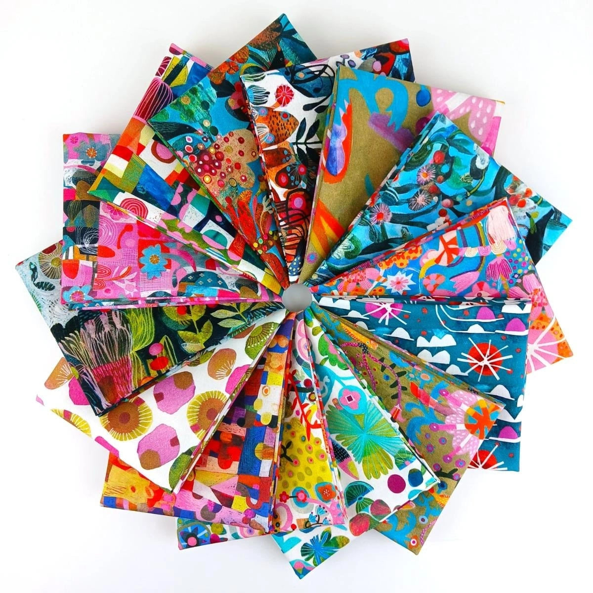 A circular display of vibrant, patterned one-yard cuts from the Jaftex - FreeSpirit Colori One Yard Bundle, featuring florals, animals, and abstract designs on a white background.