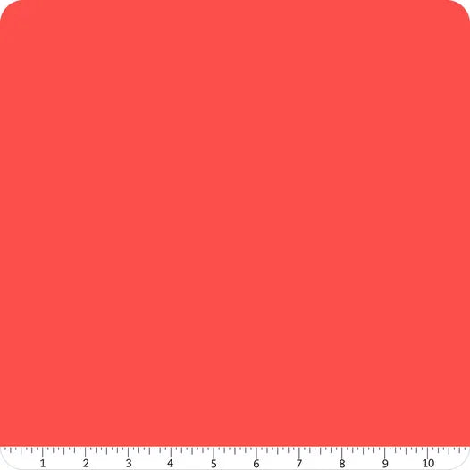 A square of solid cayenne red Confetti Cotton™ fabric with rounded corners. Along the bottom, a white ruler marked 1-10 inches shows scale—ideal for Riley Blake quilting projects using Confetti Cotton™ Cayenne Fabric Yardage.