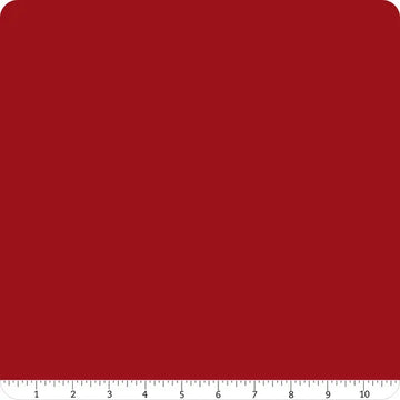 A square of Confetti Cotton™ Cherry Tart solid fabric by Riley Blake with rounded corners. A white ruler marked 1–10 inches runs along the bottom, showing scale—perfect for quilting and sewing projects.
