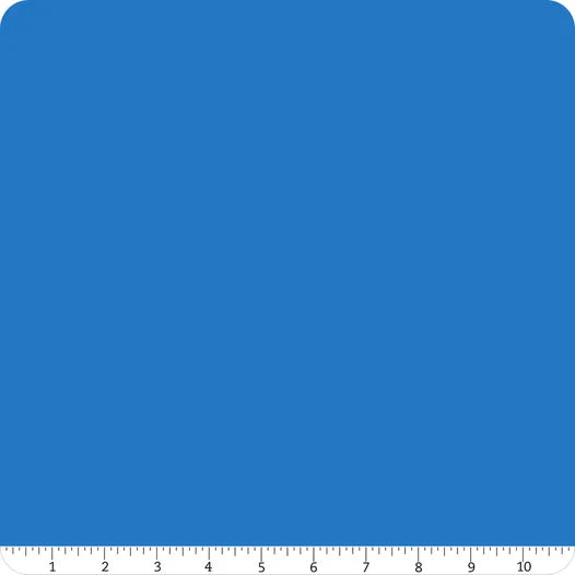 A square of Riley Blake Confetti Cotton™ Cobalt Fabric Yardage with rounded corners is displayed on a white background. A ruler from 0–10 inches at the bottom highlights its suitability for quilting and cotton fabric projects.
