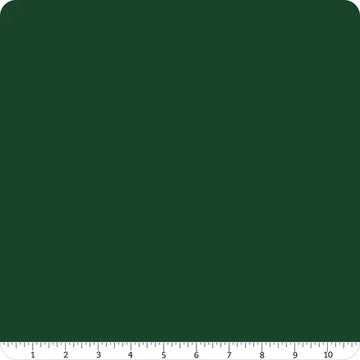 A square, dark green mat with rounded corners and a white ruler (1–10) is perfect for cutting Confetti Cotton™ Woodland Solid Fabric Yardage by Riley Blake.