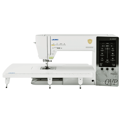 The JUKI Hayate DX-4500QVP with its wide extension table fitted, showing the 7 inch touchscreen on the right of the head.