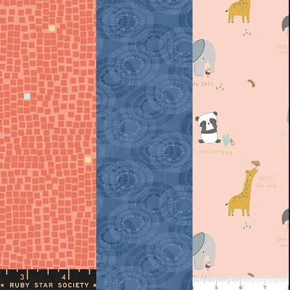The Quilted Joy Little Things 3 Yard Quilt Top Bundle features 100% cotton: coral with small squares, blue with abstract circles, and pale pink with animals and text—ideal for Fabric Cafe quilt patterns. Inches are marked by black-and-white rulers below.