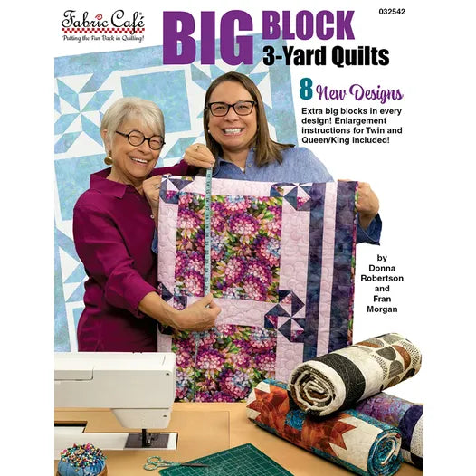 Two smiling women display a vibrant quilt on the cover of "Big Block 3-Yard Quilts" by Checker Distributor. Three rolled quilts and a white sewing machine sit on the table, showcasing easy patterns made with just 3-yard cuts.
