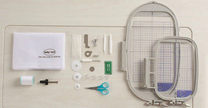 Accessories for the Baby Lock Flare Dedicated Embroidery Machine with FREE Online Classes—including two hoops, scissors, bobbins, needles, spool, screwdriver, and instruction manual—neatly arranged on a light surface.