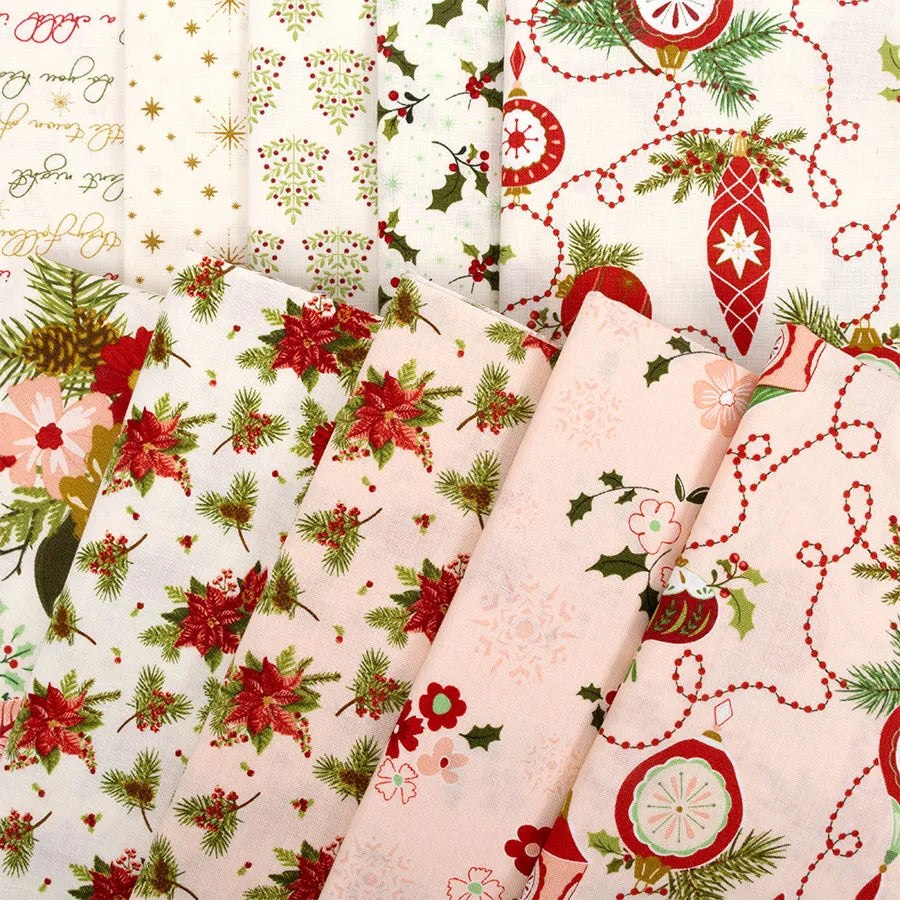The Glisten 10 Inch Stacker features festive holiday fabrics with Christmas patterns—poinsettias, holly, ornaments, and script—in red, green, and gold, ideal for precut quilting projects.