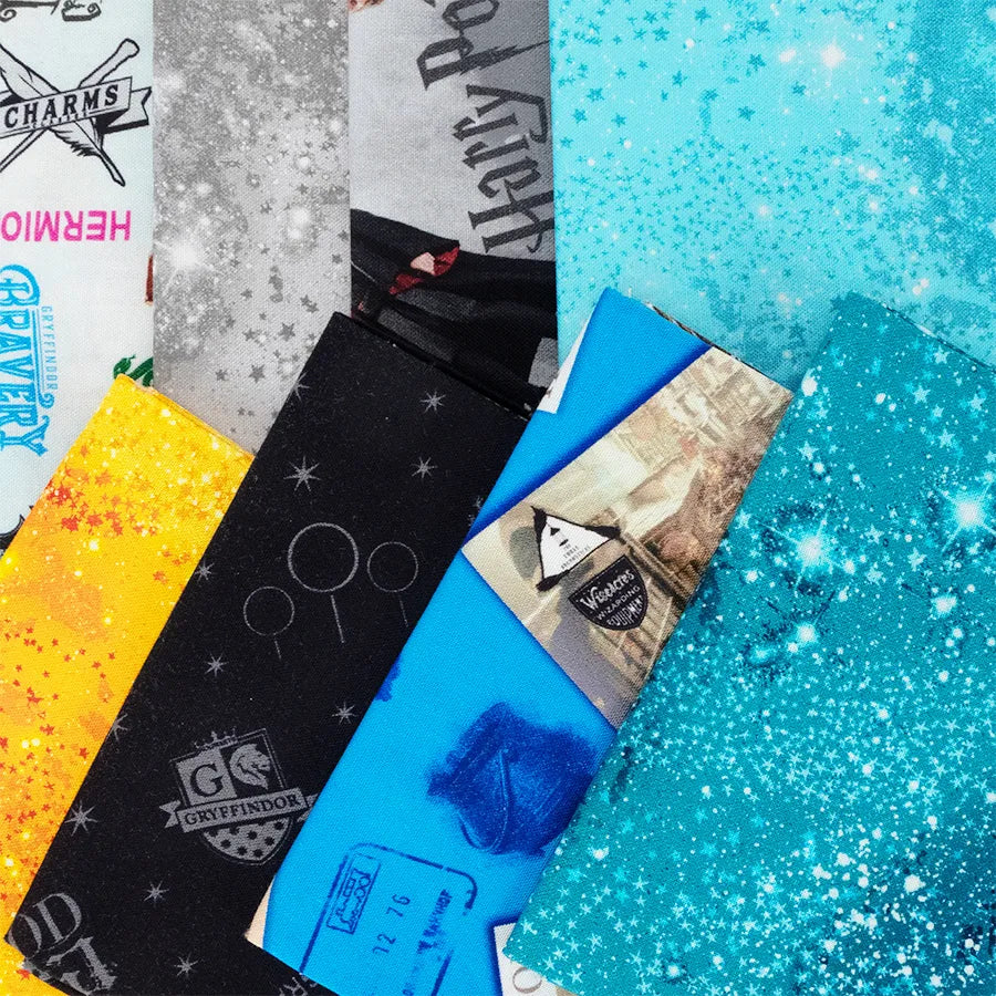 The Benartex Harry Potter Fat Quarter Bundle features colorful fabric strips with house crests, spell names, ticket motifs, and star patterns in a diagonal layout.