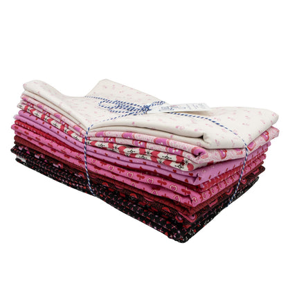 The Andover Heart and Soul One Yard Bundle features neatly folded fabric squares in pinks, creams, and dark shades, tied with blue and white string. Each unique small-patterned fabric comes in convenient one-yard cuts.