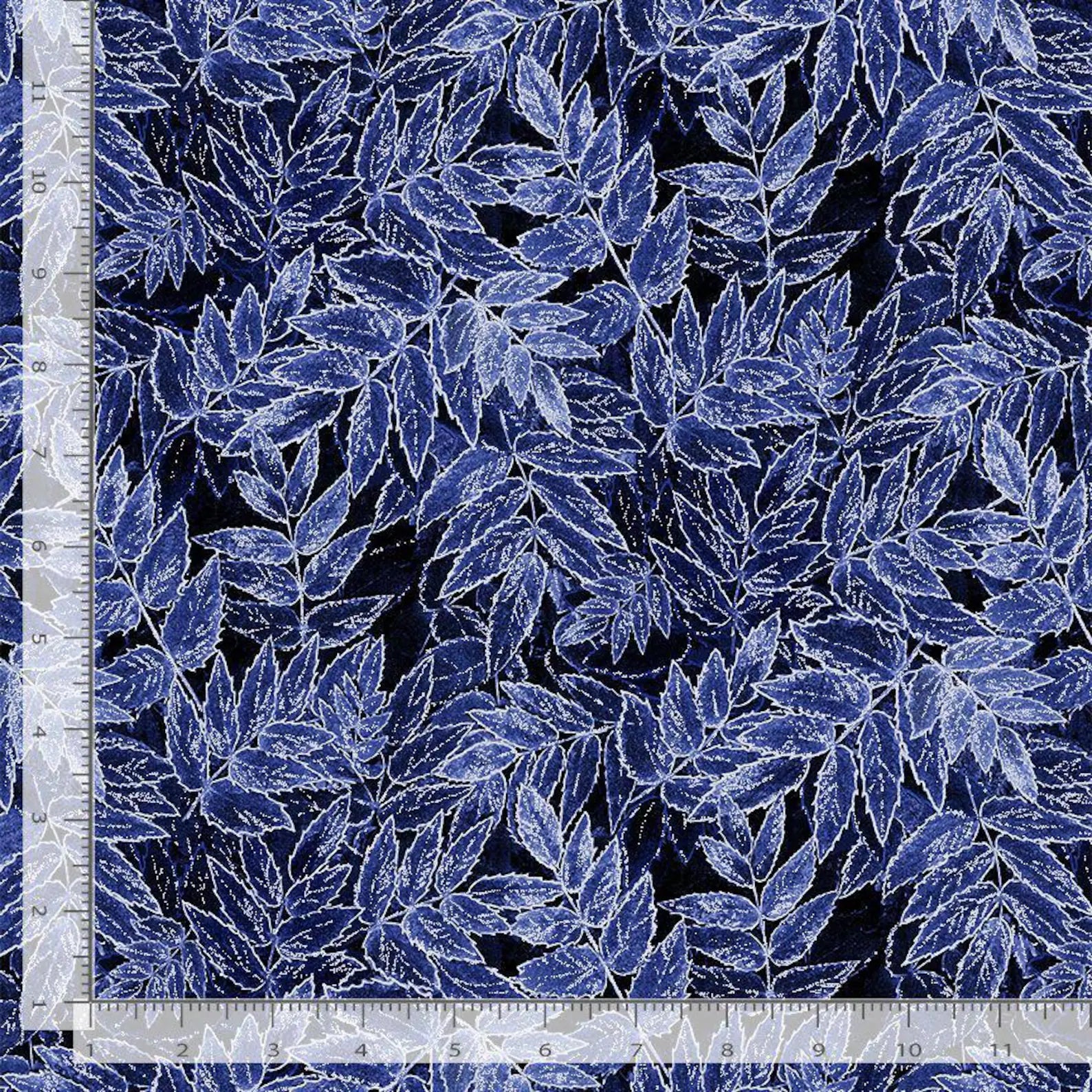 Timeless Treasures Ice Indigo Frosted Leaves Glitter Metallic Fabric Yardage features a dense blue and white outlined leaf pattern on a dark background, shown with an inch ruler along the left and bottom edges for measurement.