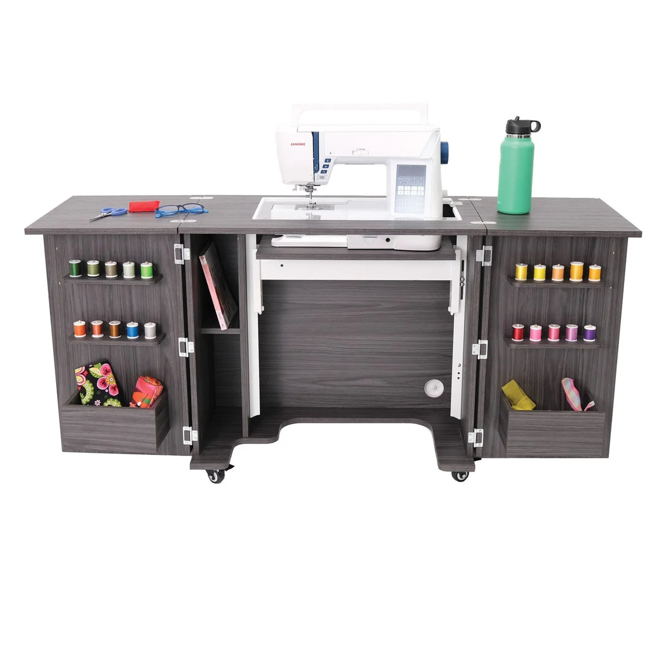 The Kangaroo Bandicoot II Sewing Cabinet by Arrow Companies, LLC is a gray compact cabinet with an open design, EZ Lift, and cabinet doors displaying a sewing machine, scissors, threads, fabric, and accessories.