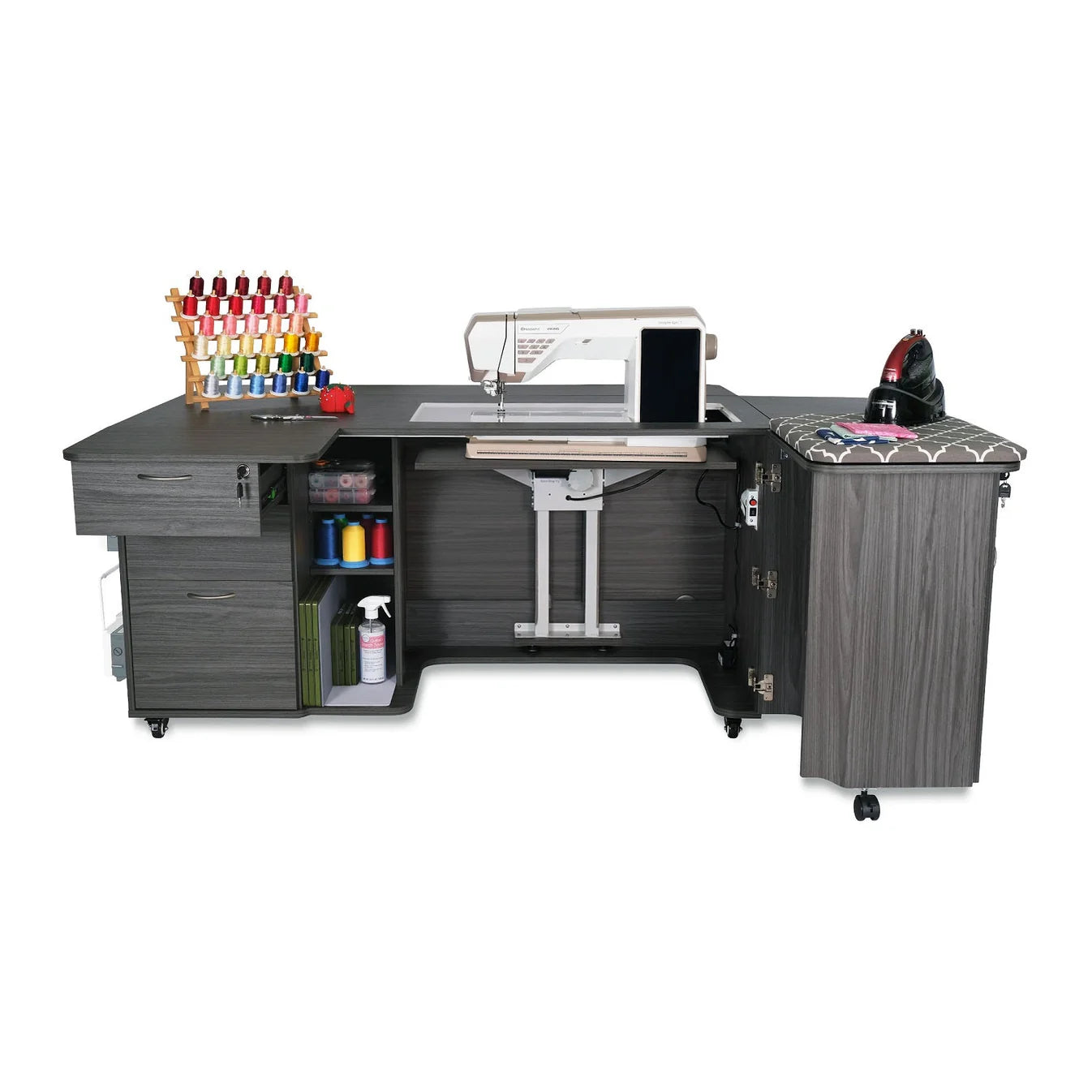 The Kangaroo Sydney Sewing Cabinet with Electric Lift by Arrow Companies, LLC features shelves, drawers, and cabinets for storage, plus space for a sewing machine, thread rack with colorful spools, spray bottles, fabric, and an ironing pad.