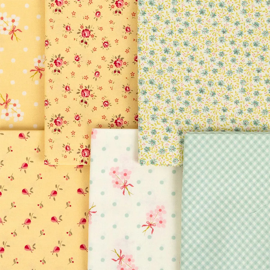 Six Lyda Rose Mini Charms from United Notions are arranged in a grid, showing small florals, polka dots, and blue gingham patterns in soft pastel yellow, blue, and white shades.