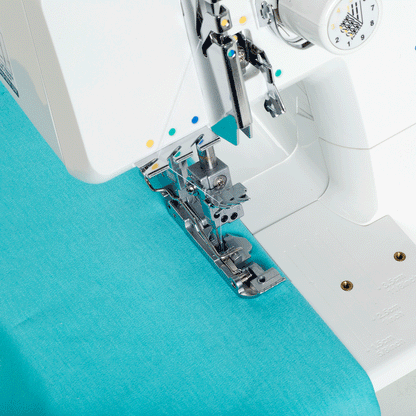 A coverstitch being sewn on teal knit fabric by the JUKI MCS-1700QVP, with the presser foot and needles at work.