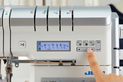 The LCD screen of the JUKI Akane MO-3000QVP showing a stitch diagram and its settings, with a finger on the arrow keys and the color marked thread guides above.