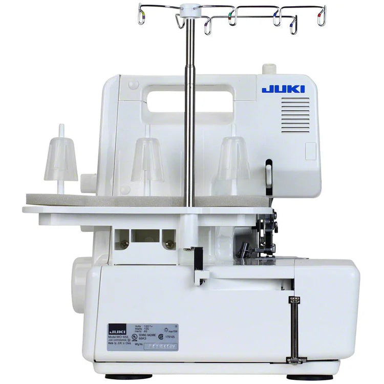A front view of the Juki America Pearl Line MO-655 2/3/4/5 Thread Serger displays multiple spool holders, thread guides, and adjustment dials, with the Juki logo on the top right.