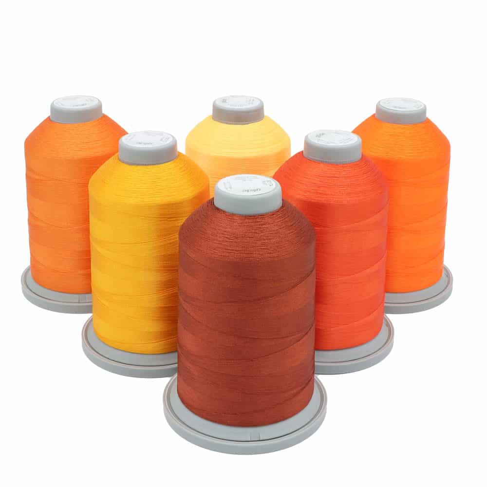 Glide Thread Color Block Bundle - Orange - six cones of orange Glide thread on a white background