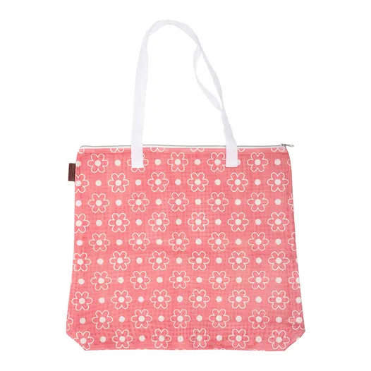 The Big Daisy Project Bag is a pink tote with white handles and white and red-outlined flowers, featuring a top zipper closure—perfect for storing your quilting accessories or using as a stylish quilt project bag.
