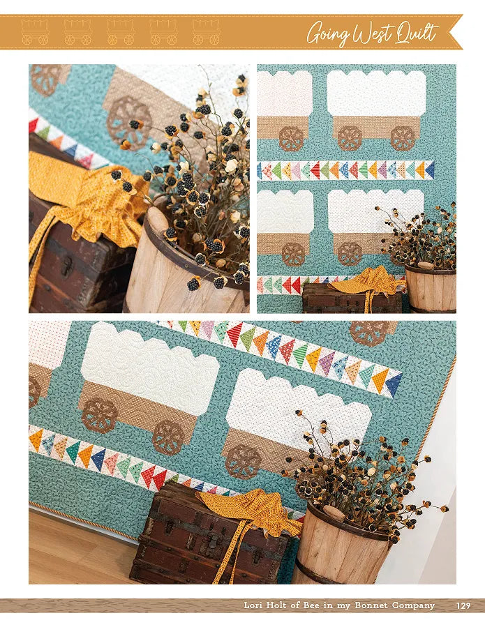 The Prairie Home Quilt Book by Checker Distributor, featuring covered wagon designs and colorful triangles inspired by Lori Holt’s style, is displayed with a wooden barrel of dried flowers and a vintage suitcase.
