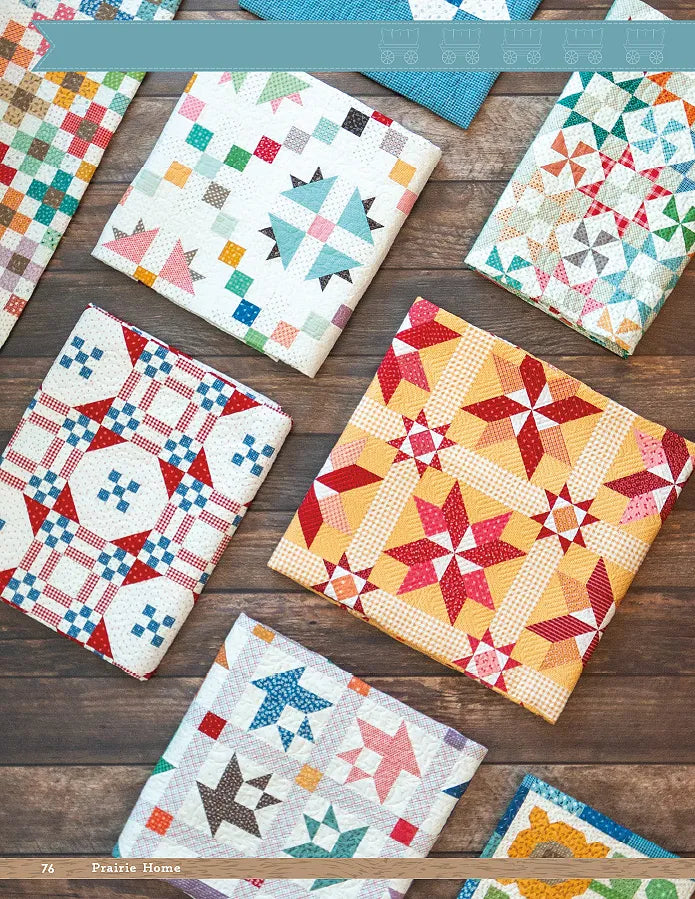 Colorful quilts, inspired by Checker Distributor’s Prairie Home Quilt Book, with traditional patchwork and geometric star patterns in red, yellow, blue, and more are displayed on a rustic wooden surface.