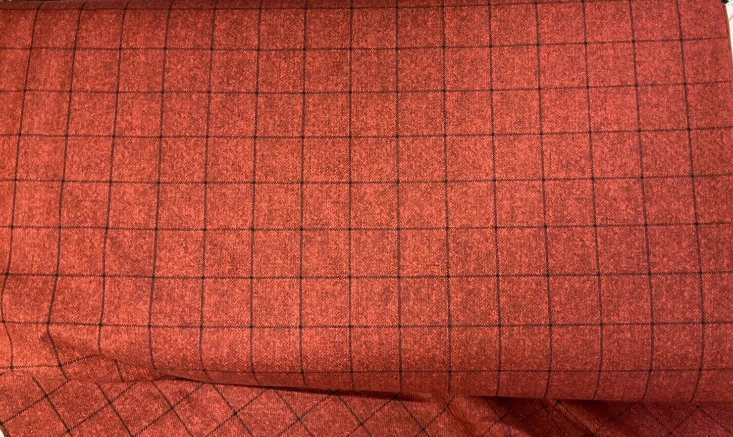 Close-up of Wooly Window Cranberry Fabric Yardage featuring a rich red surface with a subtle black grid. Thin lines form neat, evenly spaced squares, and a section of the fabric is folded at the bottom of the image.