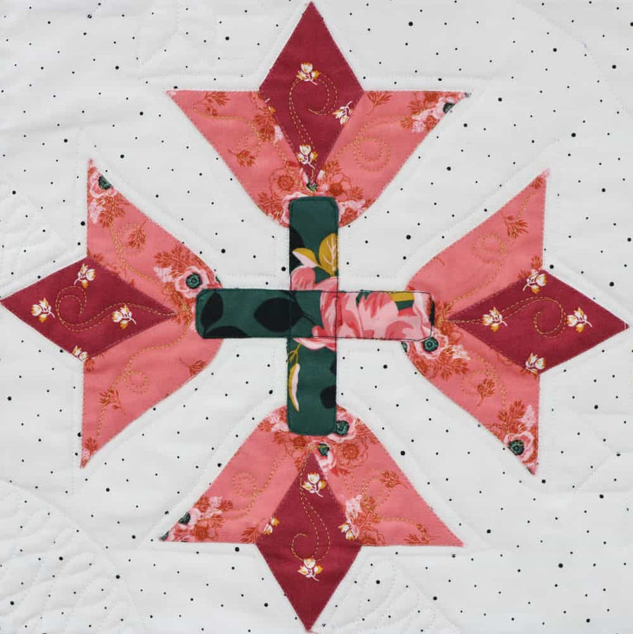 Pink and green cross quilt block with custom quilting