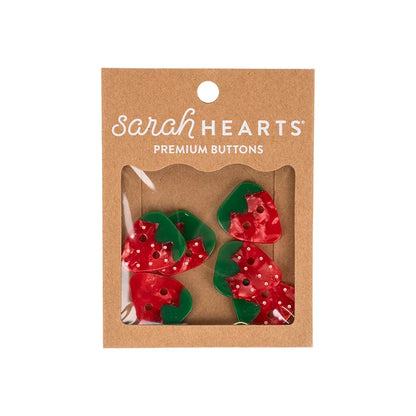 Four red and green 1" Large Strawberry Buttons by Checker Distributor come in a brown cardboard package with a clear window—plant-based acetate and perfect for sewing accessories.