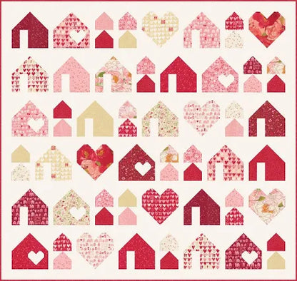 The Heartfelt Homes Quilt Kit by Quilted Joy features houses and hearts in red, pink, cream, and florals on white—perfect for showcasing your Darling Peony Layer Cake in a charming, organized design.