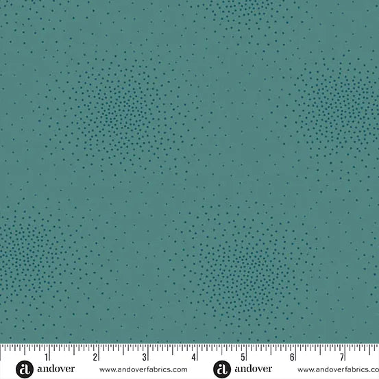Spritz Peacock Fabric Yardage by Andover features teal quilting fabric with small, dark dots forming circular, gradient patterns. A ruler in inches shows it’s ideal for precise measurements.