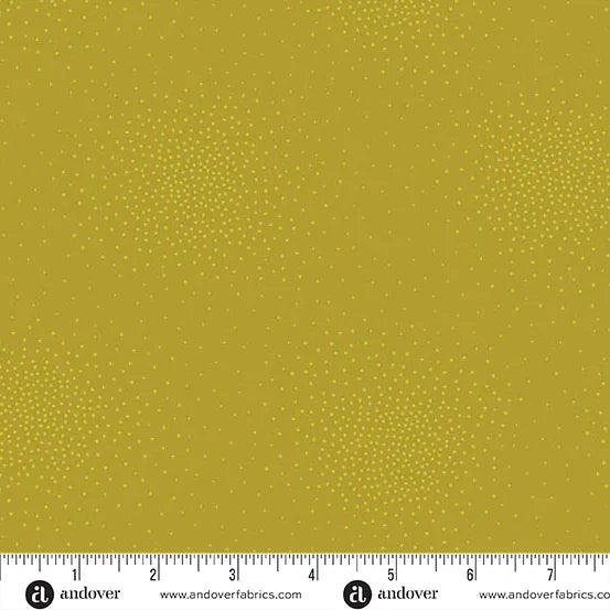 Andover's Spritz Olive Oil Fabric Yardage features olive green quilting fabric with small yellow dots. A white ruler in inches lines the edge, and the Andover logo, website, and product name appear along the border.