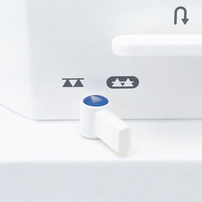 The drop feed lever on the JUKI TL-15 with the raised and lowered feed dog icons printed beside it and the reverse arrow above.