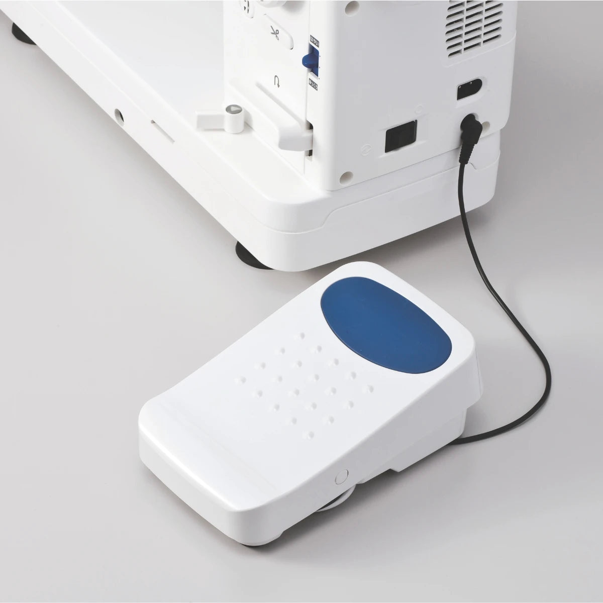 The foot controller supplied with the JUKI TL-15, cord running back to the base of the machine.