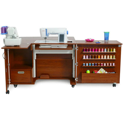 The Quilted Joy Kangaroo Wallaby Sewing Cabinet Set (available in 2 colors) features storage compartments, colorful thread shelves, space for two machines, a cup holder on the right, an open design, wheels, and a convenient Dual Rail Electric Lift.