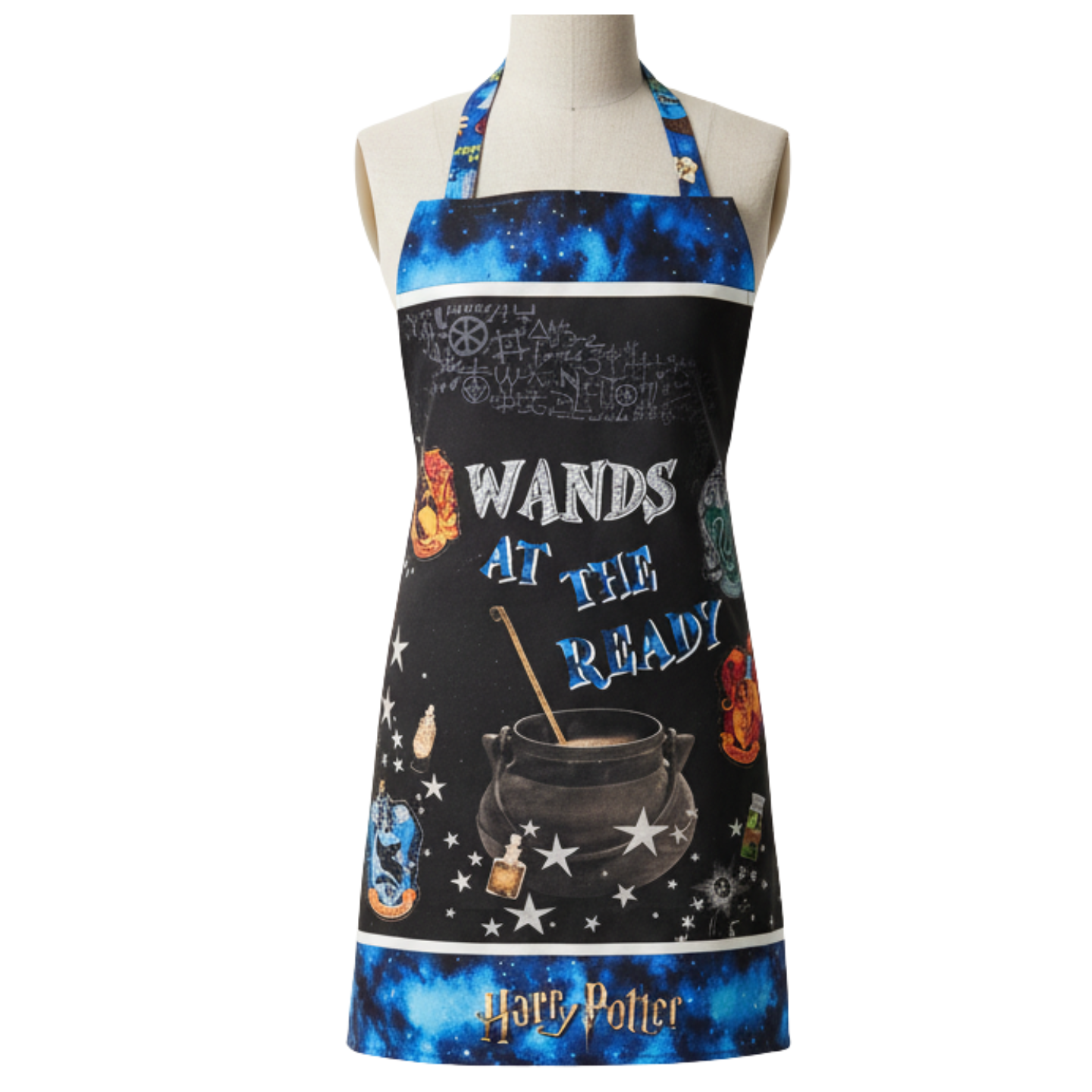 A mannequin models the Quilted Joy Harry Potter Apron Class, featuring a starry blue border, magical symbols, potion bottles, a black cauldron, and "WANDS AT THE READY" in bold letters.
