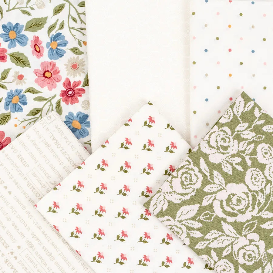 Five pieces from the Wild Honey Charm Pack by United Notions are arranged in a fan, showing floral prints, polka dots, text on white, tiny pink flowers on white, and green with white roses.