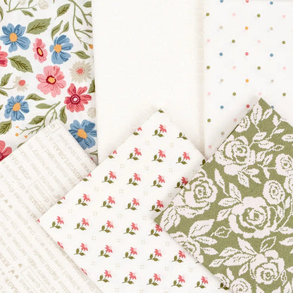 Five pieces from the Wild Honey Charm Pack by United Notions are arranged in a fan, showing floral prints, polka dots, text on white, tiny pink flowers on white, and green with white roses.