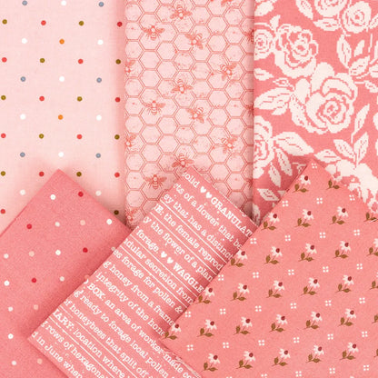 Five pieces of pink quilting cotton from the Wild Honey Charm Pack by United Notions, featuring polka dots, bees on honeycomb, text, roses, and small florals, are arranged overlapping each other.