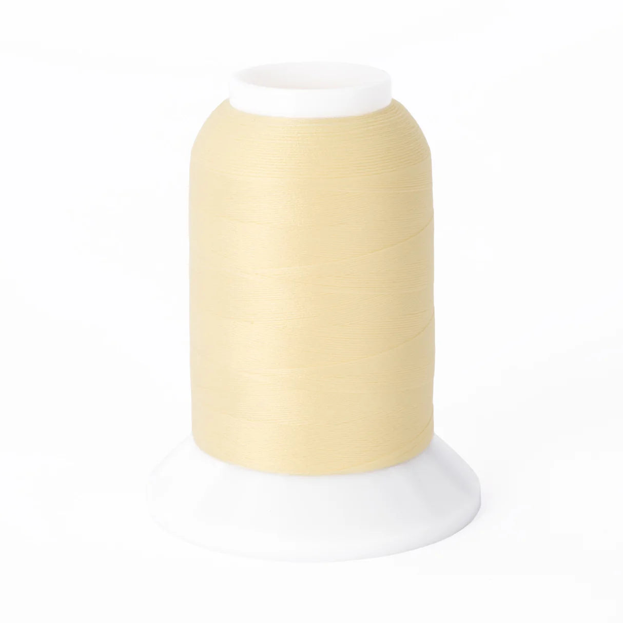 A large spool of Brewer Sewing Woolly Nylon #067 Eggshell 1000m thread stands upright on a white plastic base, set against a plain white background.