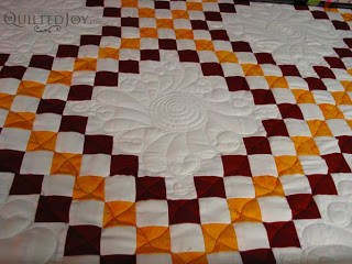 Curly Feathered Wreaths on Irish Chain quilt, quilted by Angela Huffman
