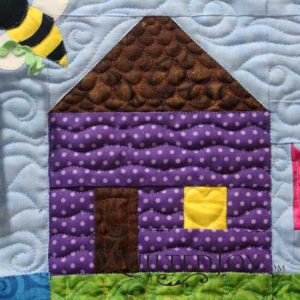 The second house on Quilted Joy's row is purple in remembrance to one of our favorite musicians, Prince