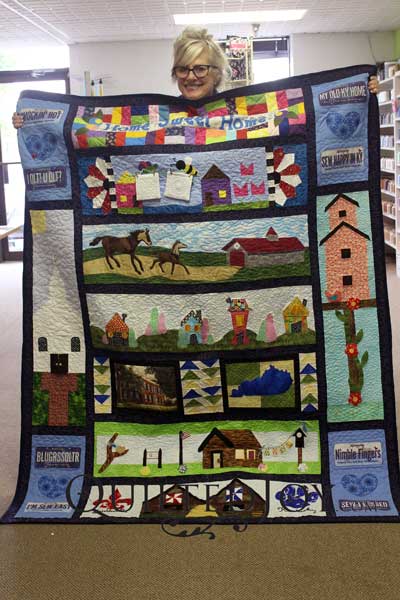 Karen shows off her winning quilt from Row by Row 2016