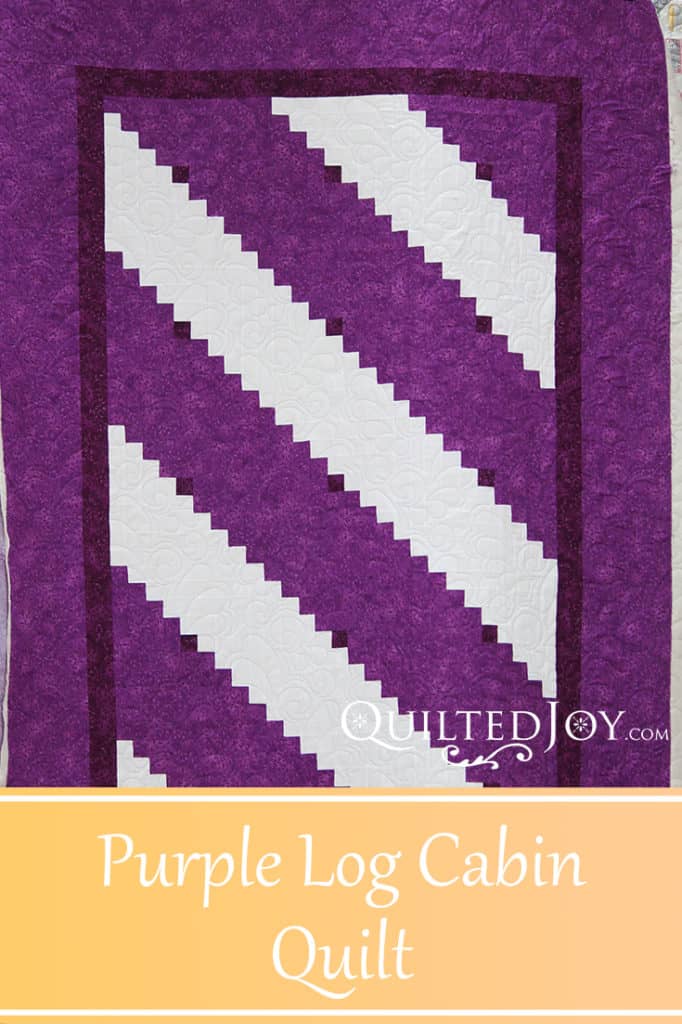 A beautiful purple and white log cabin quilt. Quilted by Angela Huffman