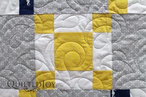 This quilt for a lucky baby boy and his parents sports tiny seahorses and lots of leaves.