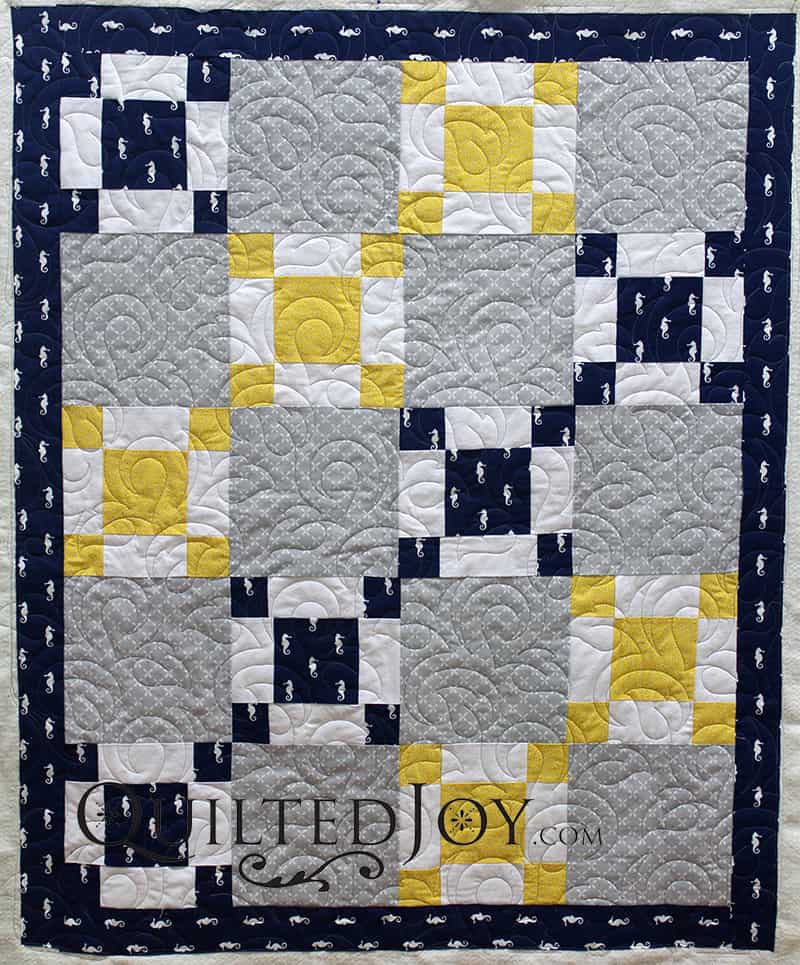 This quilt for a lucky baby boy and his parents sports tiny seahorses and lots of leaves.