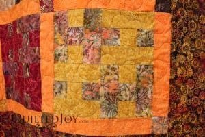 Susan's quilt is a tesselating design made entirely of batiks. I quilted it with a neutral thread that blends well and a meandering design. Fun!