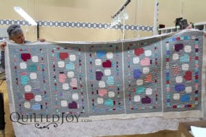Colleen quilted 5 wintery table runners at the same time using the APQS Freddie at Quilted Joy