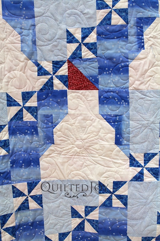 Angela quilted Dorothy's adorable snowman quilt with a fun snowflake pantograph.