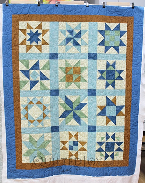 Jodi made a beautiful blue, green, and gold sampler quilt and asked me to quilt it for her. We looked at her fabrics for inspiration to choose the perfect edge to edge design.