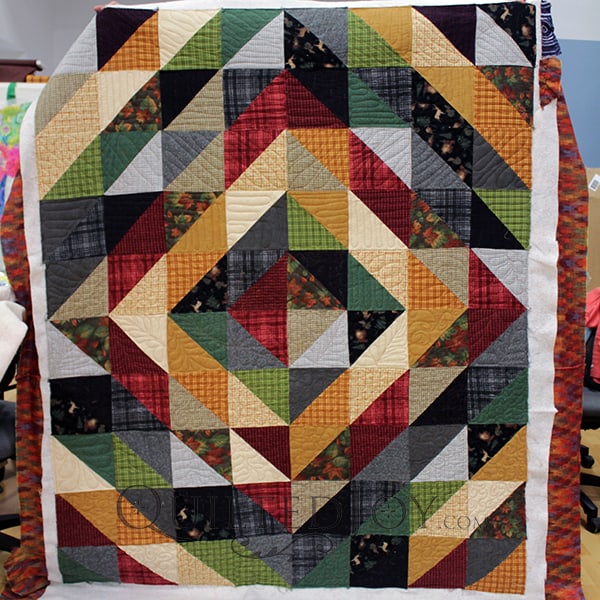 Debbie free motion quilted her flannel quilt on an APQS longarm quilting machine at Quilted Joy.