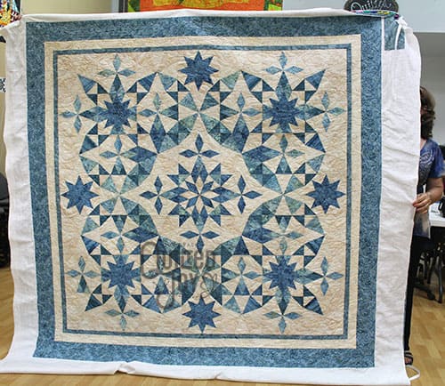 Anna Maria shows off her Alaska quilt after renting a longarm machine at Quilted Joy