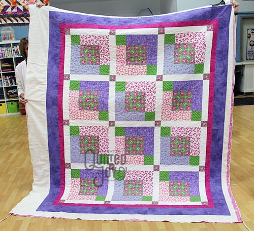 Nancy's Purple Flowers Quilt after quilting it at Quilted Joy